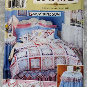 May include: A sewing pattern for a bedroom set with a floral print. The pattern includes instructions for a bed skirt, pillows, and a table cloth. The pattern is called "Daisy Kingdom" and is from Simplicity Home.