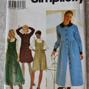 May include: A Simplicity sewing pattern envelope, number 752, size BB L,XL. The front displays illustrations of four different dress styles labeled A, B, C, and D, featuring various lengths, button-front closures, and long sleeves with collars.