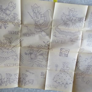 May include: A vintage paper featuring seven illustrations of Dutch girls, each representing a day of the week. The drawings are in black ink, with the days of the week written in reverse. The paper is folded and has a yellowed appearance.