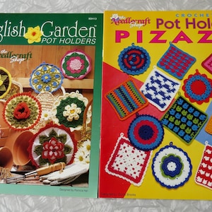 May include: Two vintage crochet pattern books. The left book is titled "English Garden Pot Holders" and features colorful crochet pot holders. The right book is titled "Crochet Pot Holder PIZAZZ" and shows various crochet pot holder designs.