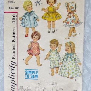 May include: Vintage Simplicity sewing pattern for a 18 inch doll. The pattern includes five different outfits: a blue and white striped dress, a yellow dress with white flowers, a floral print dress, a pink and white pinafore, and a floral print nightgown. The pattern is labeled "Simplicity Printed Pattern 45c" and "4839 Pearl K."