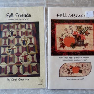 May include: Two quilt pattern packets. The "Fall Friends" pattern features a finished quilt top measuring 50" x 70". The "Fall Memor" pattern includes a raw edge appliqué quilt pattern with a finished quilt size of 34" x 26" and a table runner 36" x 14".