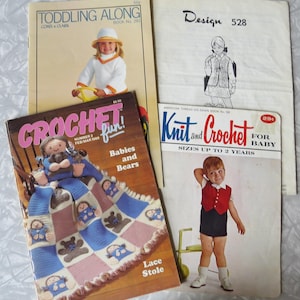 May include: A collection of vintage crochet and knitting pattern books. Titles include "Toddling Along," "Design 528," "Crochet Fun! Babies and Bears," and "Knit and Crochet for Baby." The covers feature illustrations and photographs of children and crochet projects.