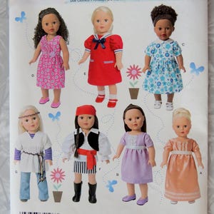 May include: Simplicity doll clothes pattern J0441. The pattern features various doll outfits, including dresses, a pirate costume, and a peasant outfit. The pattern is designed for 18-inch dolls (45.5 cm).