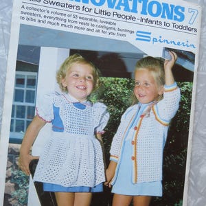 May include: A book titled "Spinnovations 7: Little Sweaters for Little People - Infants to Toddlers" featuring two young girls wearing crocheted sweaters and dresses. The book is from Spinnerin and costs $250.