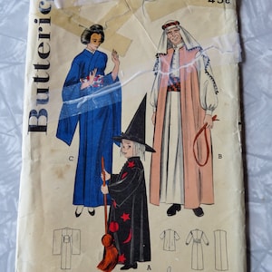 May include: Vintage sewing pattern for three costumes: a witch, a geisha, and a Middle Eastern man. The pattern is from Butterick and is number 6343. The pattern is for a chest size of 30 inches.