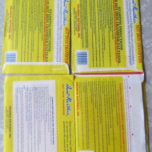 May include: Four vintage Aunt Martha's Hot Iron Transfer pattern packets. Each packet features yellow and red packaging with instructions and the text "Stamping Directions". The packets are from Colonial Patterns, Inc.
