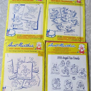 May include: Four vintage Aunt Martha's Hot Iron Transfer packets. Each packet has a yellow background with blue and white designs. The packets are labelled for embroidery, fabric painting, and other crafts. Designs include tea towels and colonial girl motifs.