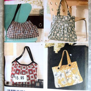 May include: Simplicity sewing pattern 2685 for one size handbags. The envelope displays four bag variations: a black and white geometric print, a green floral print, a red and white square pattern, and a yellow floral print with buttons.