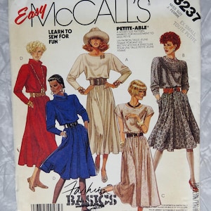 May include: Vintage McCall's sewing pattern featuring illustrations of dresses. The pattern includes the text "Easy McCall's" and "Fashion Basics". The pattern is for petite sizes and includes instructions for overlock sewing.