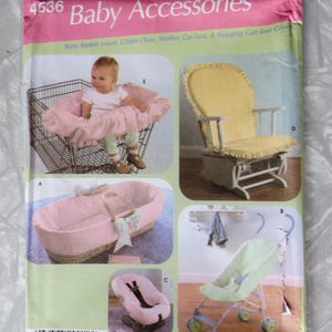 May include: Simplicity Home Decorating pattern 4536 for baby accessories. Includes patterns for a baby basket insert, glider chair, stroller, car seat, and shopping cart seat covers. The cover art features a baby in a shopping cart with a pink cover.