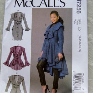 May include: McCall's M7256 sewing pattern envelope for a coat with a large ruffled collar, long sleeves, and a high-low hemline. The front displays illustrations of three variations labeled A, C, and D, and a photograph of version B in blue.