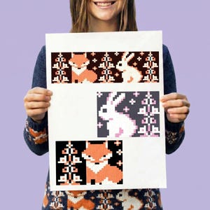 May include: A white paper sheet featuring three distinct pixel art patterns. The top section shows a fox and a rabbit with trees. The middle section displays a white rabbit with trees. The bottom section depicts a fox with trees in a pixelated style.