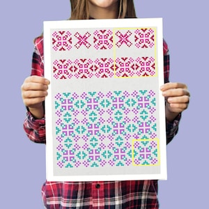 May include: A white canvas with a repeating pattern of pink, purple, and teal squares. The pattern is made up of small squares arranged in a geometric design.