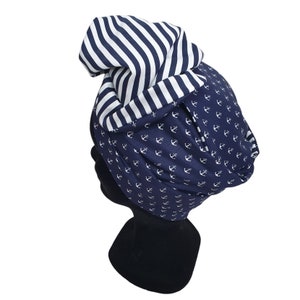 Puede incluir: Un turbante de estilo marinero, azul marino con anclas blancas y una secci&oacute;n a rayas blancas y azul marino. El sombrero est&aacute; dise&ntilde;ado para a&ntilde;adir un toque de estilo.
