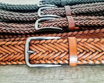 May include: A stack of braided leather belts with silver buckles. The belts are in various shades of brown and tan.
