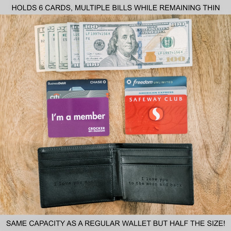 May include: A black leather wallet with a message engraved on the inside. The wallet is open and shows a cash bill, credit cards, and a membership card. The text on the wallet reads "I love you to the moon and back".