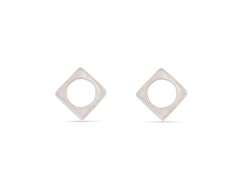 May include: A pair of silver earrings with a square shape and a circle cut out in the center.