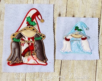 May include: Two embroidered gnome ornaments, one with a red and white striped hat and brown hair, the other with a blue hat and white hair. Both gnomes have a green holly sprig on their hats.
