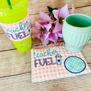 May include: A pink and white checkered fabric coaster with the text "teacher fuel" in blue and purple lettering. A small blue and white coffee cup icon is next to the text. A blue circle with white polka dots is in the corner of the coaster.