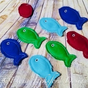 May include: A set of felt fish toys in various colors, including blue, green, red, and turquoise. The fish are all different sizes and shapes, and they have embroidered eyes and mouths.