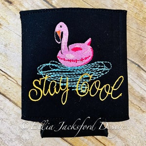 May include: Black can cooler with a pink flamingo pool float and the text "Stay Cool" embroidered in yellow thread.