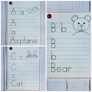 May include: Three alphabet flashcards with a red border and a hole in the top left corner. The first card shows the letter A, a lowercase a, and a drawing of an airplane. The second card shows the letter B, a lowercase b, and a drawing of a bear. The third card shows the letter C, a lowercase c, and a drawing of a cat.