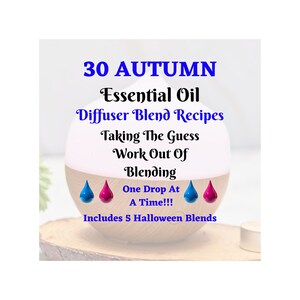 May include: A white diffuser with a wooden base, surrounded by blue and pink essential oil drops. The text reads "30 AUTUMN Essential Oil Diffuser Blend Recipes Taking The Guess Work Out Of Blending One Drop At A Time!!! Includes 5 Halloween Blends".