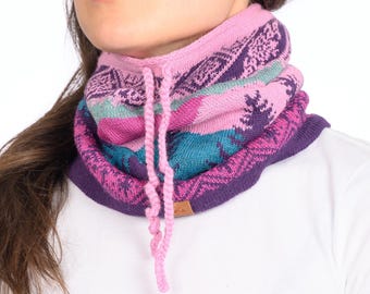 May include: A pink, purple, and blue patterned knit neck warmer with a long pink cord tie.