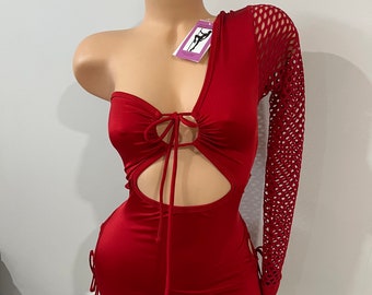 May include: A red one-shoulder romper with a cutout design and a long mesh sleeve. The romper features tie details at the chest and sides. The garment is displayed on a mannequin.