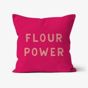 May include: A square magenta cushion featuring the text "FLOUR POWER" in a light tan hue. The cushion has a plain, vibrant design, ideal for adding a pop of colour to any room.