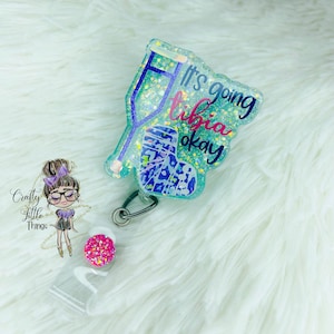 May include: A teal blue glitter badge holder with a broken leg and crutches, and the text "It's going tibia okay".