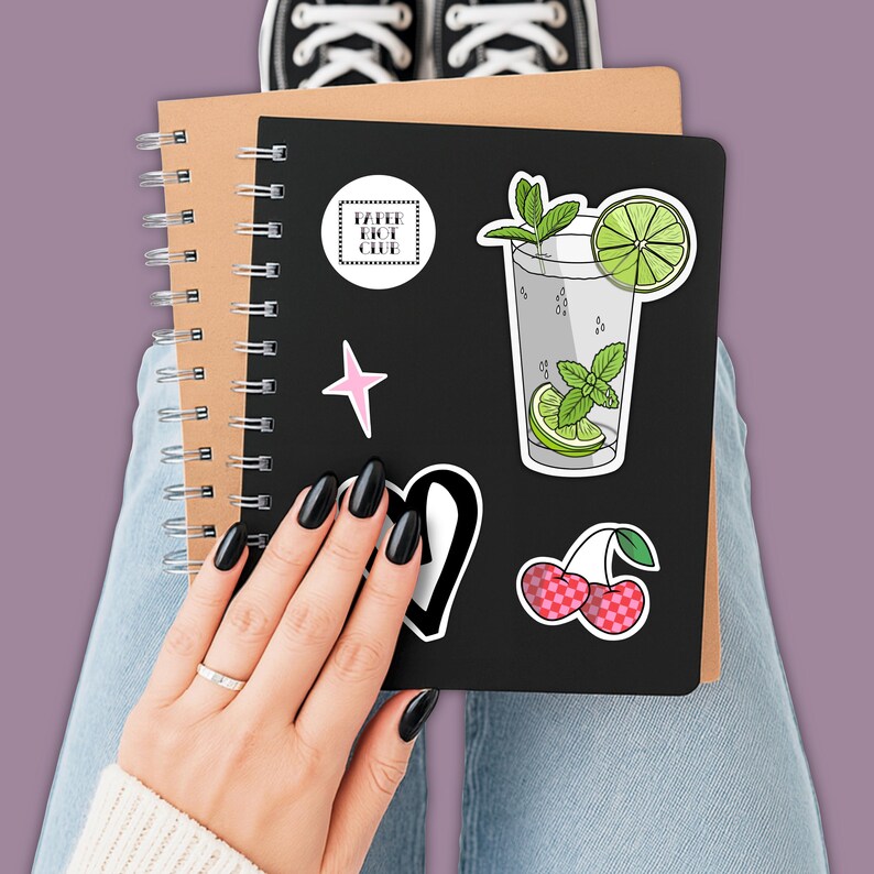 Tropical vacation vibes green mojito cocktail with lime and mint garnish die-cut vinyl sticker stuck to the front of a journal.