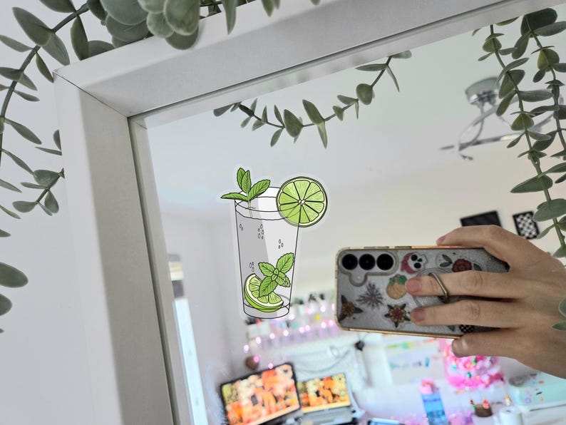 Tropical vacation vibes green mojito cocktail with lime and mint garnish die-cut vinyl sticker stuck to a mirror.