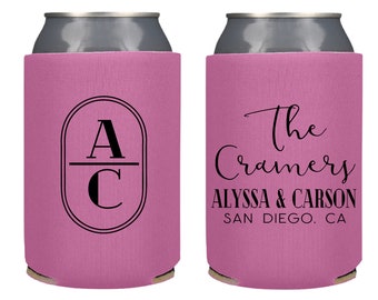 May include: Pink can cooler with black text and design. One side features the initials "A" and "C" inside an oval. The other side reads "The Cramers" with "ALYSSA & CARSON" and "SAN DIEGO, CA" below.