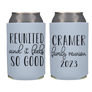 May include: Two light blue can coolers with black text. One cooler says "REUNITED and it feels SO GOOD". The other cooler says "CRAMER family reunion 2023".