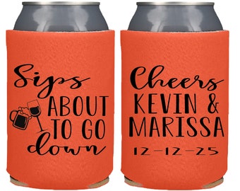 May include: Orange can cooler with black text that reads "Sips About To Go Down" with a beer mug and wine glass graphic. The other side says "Cheers Kevin & Marissa 12-12-25".