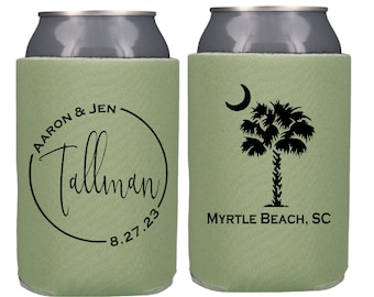 May include: Two green foam can coolers. One cooler has a black circle with the text "AARON & JEN Tallman 8.27.23". The other cooler has a black silhouette of a palm tree with a crescent moon and the text "MYRTLE BEACH, SC".