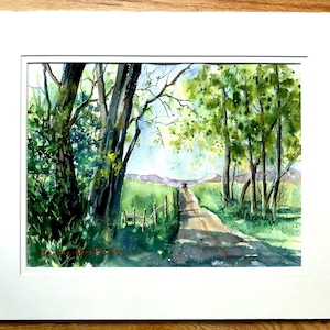 May include: A watercolor painting of a country road with trees on either side. The road leads to a distant hill with a car driving on it. The trees are green and the sky is blue.