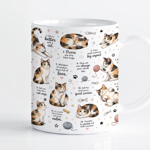 May include: A white ceramic mug featuring a repeating pattern of calico cats in various poses, interspersed with small illustrations of yarn balls, fish bones, and stars, along with numbered text phrases about cat companionship and behavior.