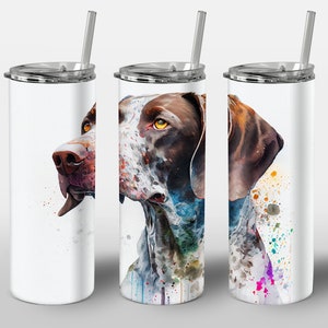 May include: Three stainless steel tumblers with a watercolor illustration of a German Shorthaired Pointer dog on each. The dog is brown and white with splashes of colorful paint.