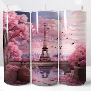 May include: Three stainless steel tumblers with a pink and white design featuring the Eiffel Tower, a bridge, and cherry blossoms. The tumblers are perfect for enjoying your favorite beverages.