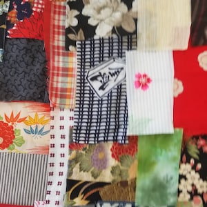 May include: A patchwork quilt made of various fabric scraps in different colors and patterns, including floral, geometric, and striped designs.