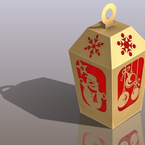 May include: A gold cardboard Christmas lantern with a red snowman, snowflakes, and ornaments cut out. The lantern has a handle on top.