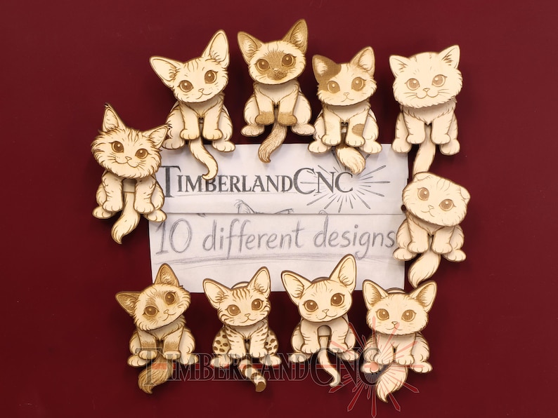 May include: Ten laser-cut wooden cat figures in various poses and expressions. A central white card features the text TimberlandCNC and 10 different designs. Each cat is rendered with detailed engraved lines, showcasing distinct facial features and fur patterns.