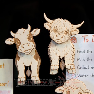 May include: Two wooden cow-shaped decorations. One is a brown and white cow with a smiling face. The other is a Highland cow with long fur and horns. A "To Do" list is visible with tasks like "Feed the chickens" and "Water the plants".