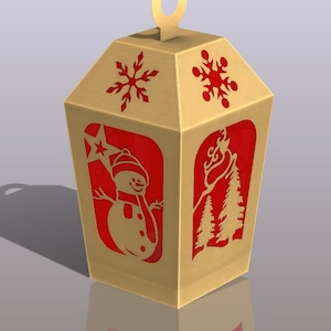 May include: A gold cardboard box shaped like a lantern with red cut-out designs of a snowman, snowflakes, and pine trees. The box has a loop at the top for hanging.
