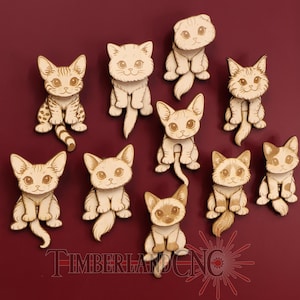 May include: A collection of ten wooden cat cutouts in various poses. Each cat has a unique design, with detailed facial features and markings. The cats are arranged on a deep red background. The text "TIMBERLAND CNC" is at the bottom.