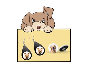 Puede incluir: Un par de pendientes negros en forma de lágrima con una foto de un perro en cada pendiente. Los pendientes cuelgan de un fondo blanco. Un perro de dibujos animados asoma por encima de la parte superior del fondo.