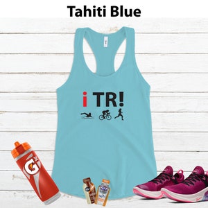 May include: Tahiti blue racerback tank top with "i TR!" text and triathlon icons. Includes a Gatorade bottle, two GU energy gel packets, and a pair of magenta running shoes.